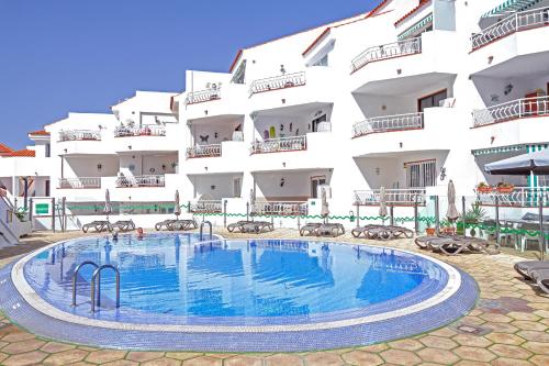 a swimming pool in front of a building at Gorgeous Los Diamantes Home in Los Cristianos