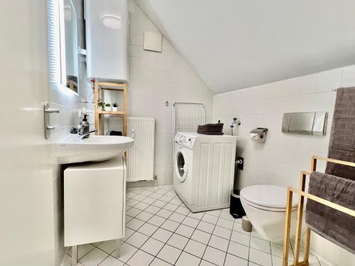 a bathroom with a sink and a washing machine at urbanstays Linz Landstraße - city center - near casino in Linz