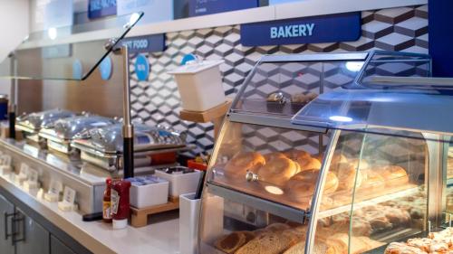 a bakery with a display case filled with pastries at Holiday Inn Express Hickory - Hickory Mart by IHG in Hickory