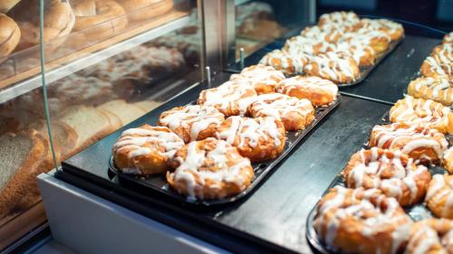 a display case in a bakery filled with lots of donuts at Holiday Inn Express Hickory - Hickory Mart by IHG in Hickory