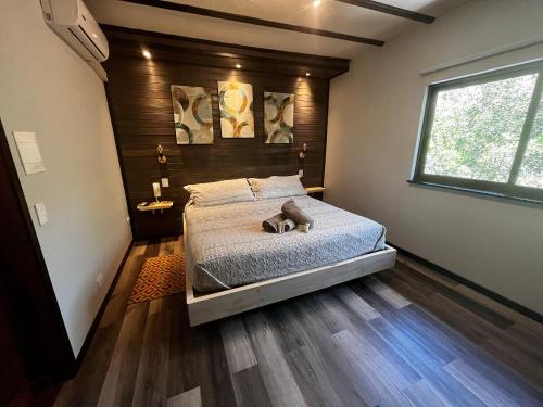 a bedroom with a bed with a wooden wall at La Petite France in San José de Maipo