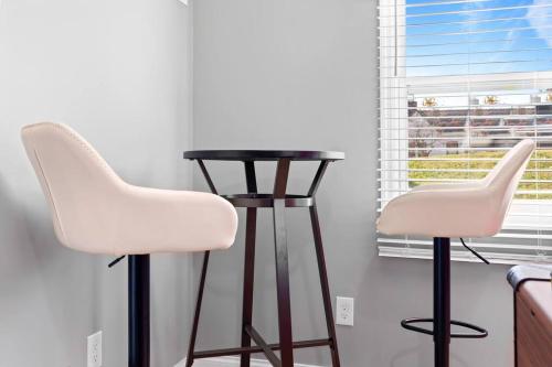 two white chairs and a table in a kitchen at Pet Friendly & Great Outdoor Space Close to Downtown in Chattanooga