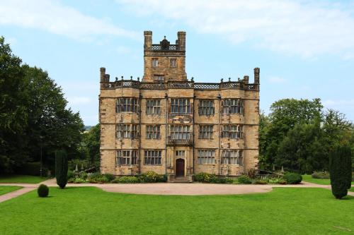 an old castle with a green lawn in front of it at Holiday Inn Express Burnley M65 Jct 10, an IHG Hotel in Burnley