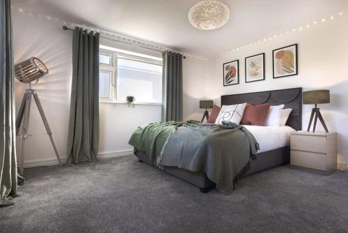 a bedroom with a large bed and a window at Scar View - Getaway for Two in Underbarrow