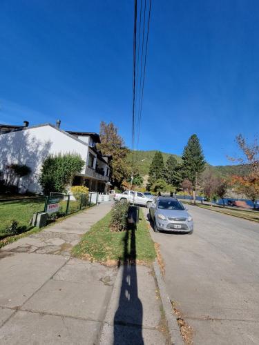 a shadow of a parking meter on a street at Puerto Lacar Lodge SMARG in San Martín de los Andes