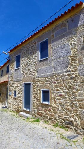 a stone building with windows on the side of it at Casa CÔA - Casas de Villar - Rural Experience in Vilar de Amargo