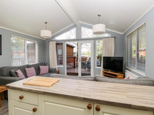 a living room with a couch and a table at Wansfell Lodge in Windermere