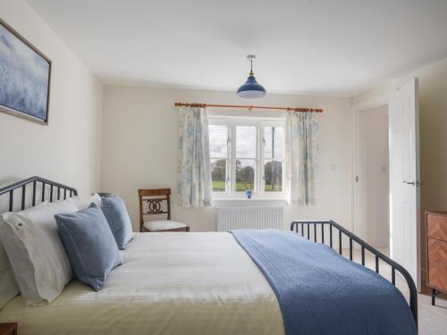 a bedroom with a bed and a window at South Glebe in Axminster