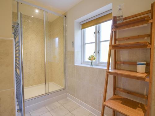a bathroom with a shower and a glass shower stall at South Glebe in Axminster