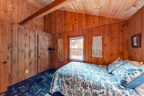a bedroom with a bed in a wooden cabin at The Red Camp in Casco