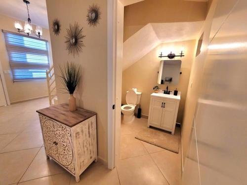 a bathroom with a toilet and a sink at Earthy 2 Story Beach House! in Puerto Peñasco