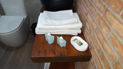 a wooden table with towels and a toilet in a bathroom at Valencia Canyamelar Beach Apartments in Valencia