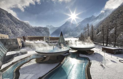 a resort with two water fountains in the snow at Haus Alpenglühn in Sautens