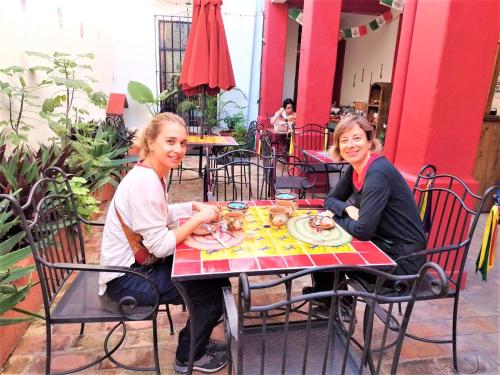 two women sitting at a table eating food at Posada Don Mario in Oaxaca City
