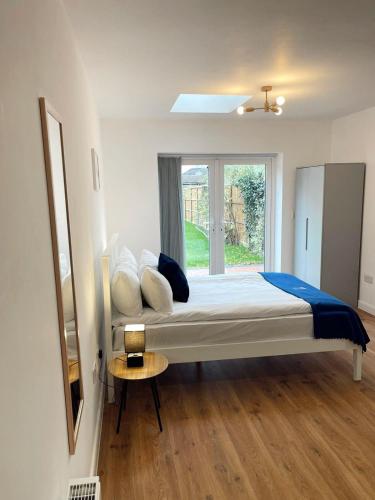 a bedroom with a large bed with a window at Cambridge Studios and Suites by Tas Accommodations in Cambridge