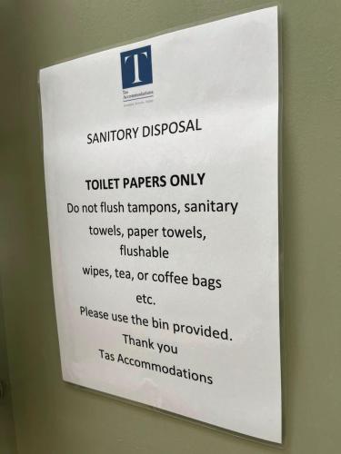 a sign on a wall that says trolley papers only at Cambridge Studios and Suites by Tas Accommodations in Cambridge
