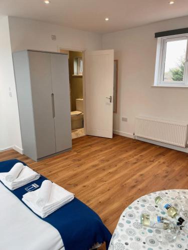 a bedroom with two beds and a wooden floor at Cambridge Studios and Suites by Tas Accommodations in Cambridge