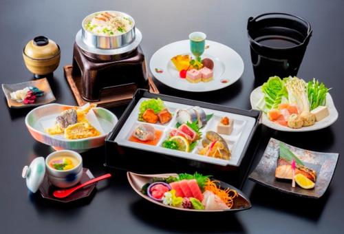 un tavolo con diversi piatti di cibo sopra di Kyukamura Nanki-Katsuura a Nachikatsuura