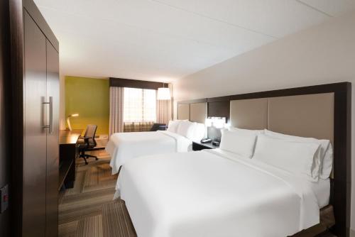 a hotel room with two beds and a desk at Holiday Inn Express Philadelphia NE-Bensalem by IHG in Bensalem