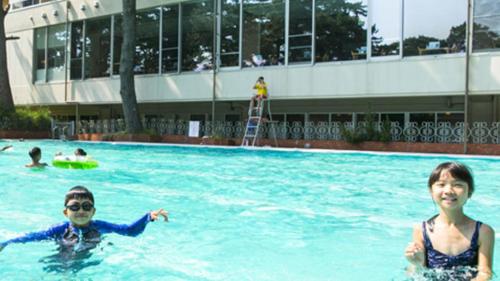 two people in the water in a swimming pool at Kyukamura Minami-Izu in Minamiizu