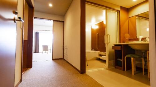 a bathroom with a sink and a mirror at Kyukamura Minami-Izu in Minamiizu