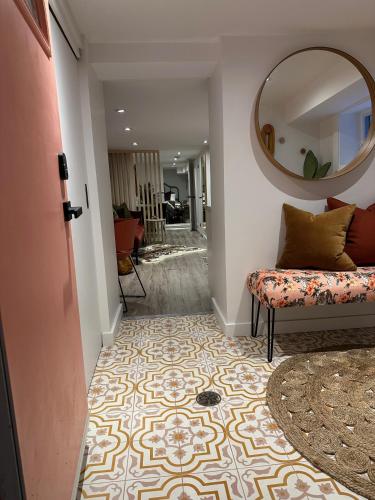 a hallway with a couch and a mirror on the wall at Professionally Designed 1-Bedroom in Prime Toronto in Toronto