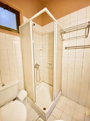 a bathroom with a shower and a toilet at Kaan Hotel & Apartment in Kérynia