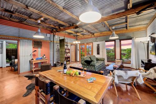 a living room with a wooden table and chairs at Sunset Cottage - Yarra Valley in Healesville