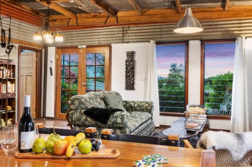a living room with a couch and a table at Sunset Cottage - Yarra Valley in Healesville