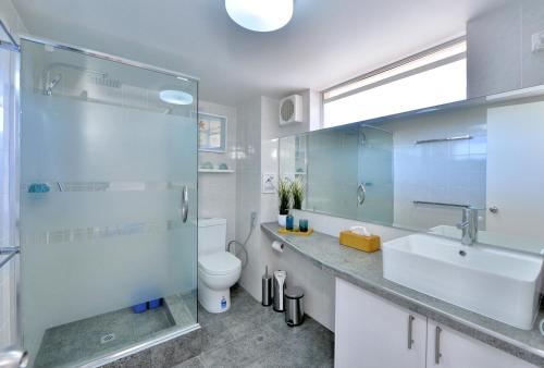 a bathroom with a sink and a toilet and a shower at 7 Heaven in Mandurah