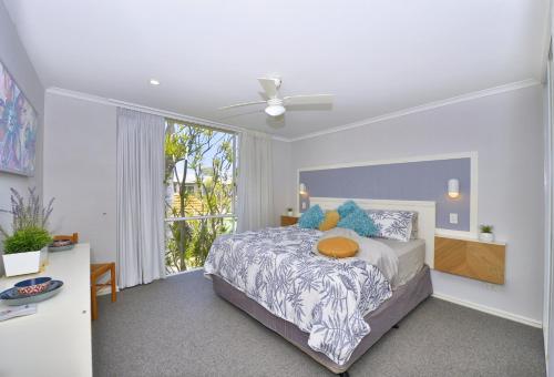 a bedroom with a bed and a large window at 7 Heaven in Mandurah