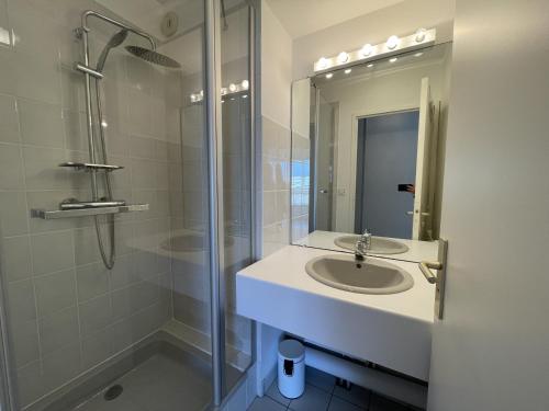 a bathroom with a sink and a shower at Bel appartement en front de mer avec balcon, parking et équipements modernes - FR-1-361-327 in Granville