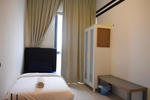 a hotel room with a bed and a window at DaMen Homestay @SubangHomeStay in Subang Jaya