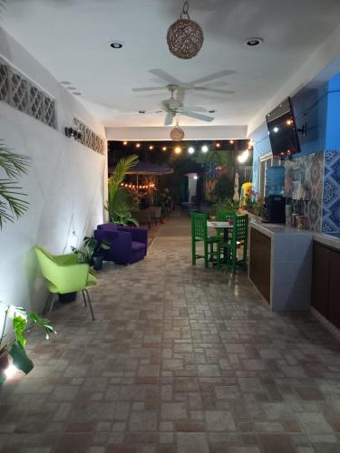 a lobby with a table and chairs and a restaurant at Casona del Negro Aguilar in Valladolid