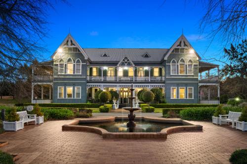 a large house with a fountain in front of it at The Convent Hunter Valley Hotel in Pokolbin