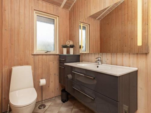 a bathroom with a sink and a toilet and a window at Three-Bedroom Holiday home in Hemmet 30 in Humble