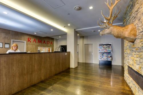a deer head on the wall of a rambala store at Ramada Suites by Wyndham Queenstown Remarkables Park in Queenstown