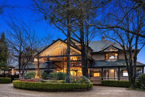 a home in the evening with its lights on at Echoes Boutique Hotel & Restaurant Blue Mountains in Katoomba