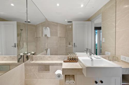 a bathroom with a sink and a tub and a shower at Echoes Boutique Hotel & Restaurant Blue Mountains in Katoomba