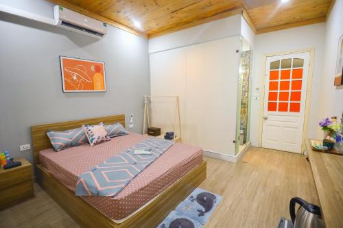 a bedroom with a bed in a room with wooden ceilings at Radish Cathedral Homestay in Hanoi