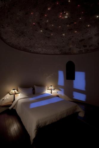 a bedroom with a bed with a star ceiling at Lazareto Hotel in Monemvasia