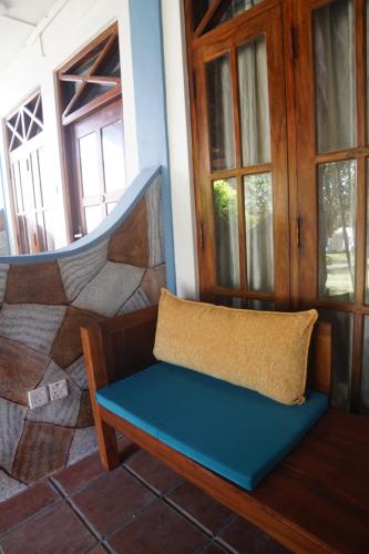 a bench sitting in a room with windows at Turtle Bay Beach Resort in Mirissa