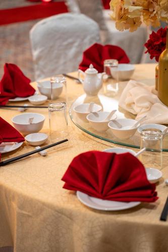 a table with red napkins and plates on it at Travelodge Ipoh in Ipoh