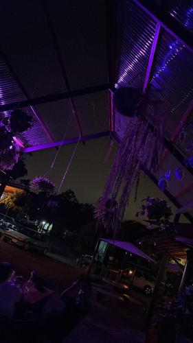 a room with purple and purple lights on the ceiling at Modern Loft inside a beautiful farm in General Viejo