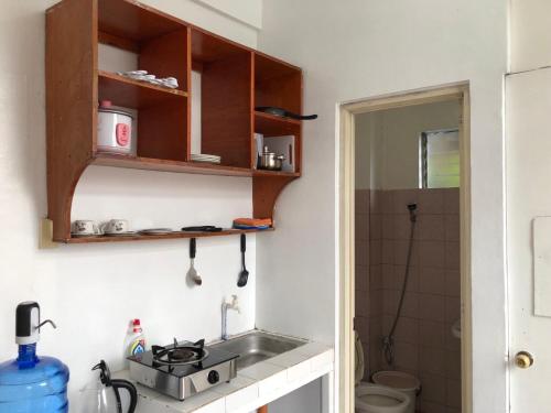 a small kitchen with a sink and a toilet at THE MANSION - 2 PAX SOLO BUDGET Room near AIRPORT TERMINAL in Manila