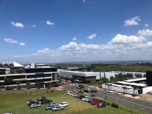 a parking lot with cars parked in front of a building at Meridian Suite Apartments in Umhlanga Ridge in Durban