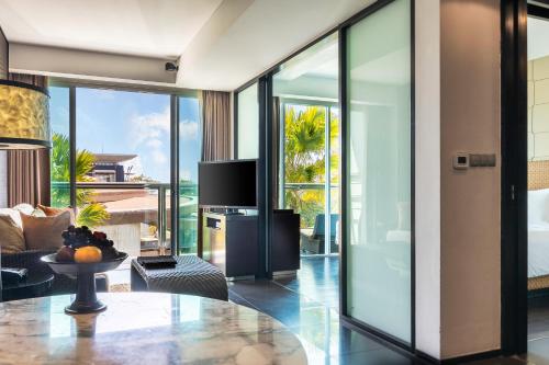 a living room with a view of the ocean at The Sakala Resort Bali All Suites in Nusa Dua