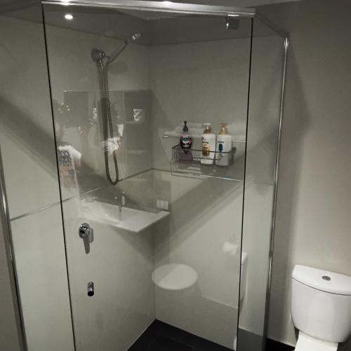a bathroom with a shower and a toilet at Margaret River Mainstreet Apartment in Margaret River Town