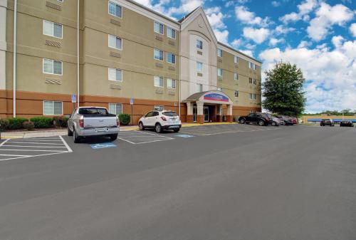 a large building with cars parked in a parking lot at Candlewood Suites Winchester by IHG in Winchester