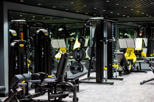 a gym with rows of exercise equipment in it at Wyndham Garden Baku in Baku